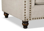 Fauteuil en tissu chenille avec garniture cloutée et pieds tournés en bois